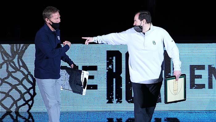 Mark Few and Scott Drew dressed in athleisure wear at the national title game